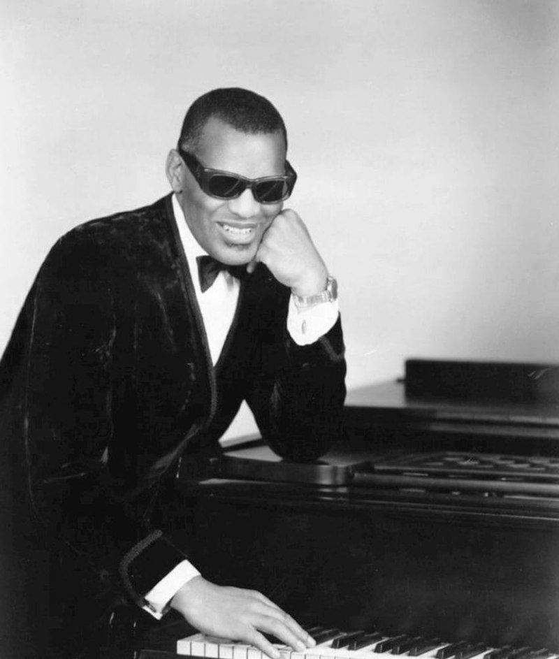 Ray Charles in the 1960s, leaning on piano